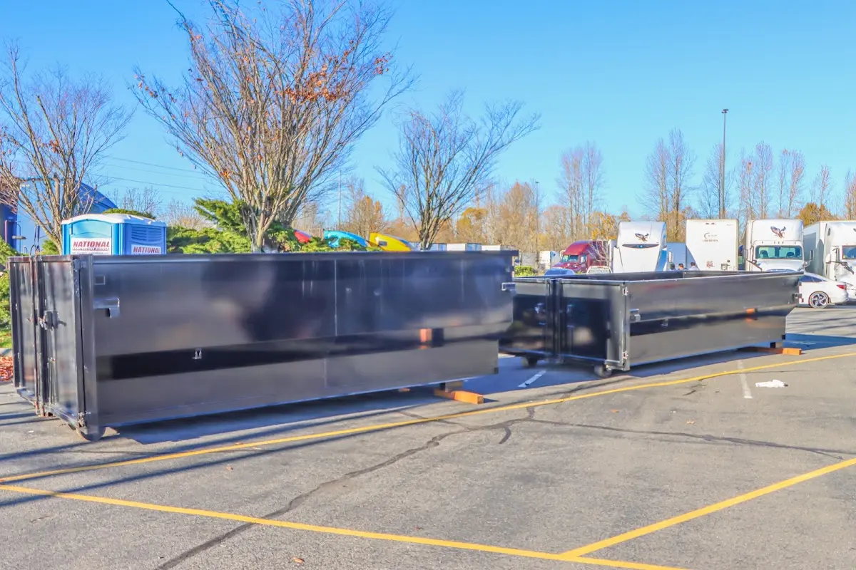 Professional dumpster rental service with roll-off container on residential driveway in Wabash